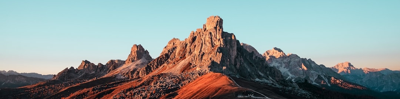 Nature LinkedIn Cover Photo with Brown Rock Formation Blue Sky