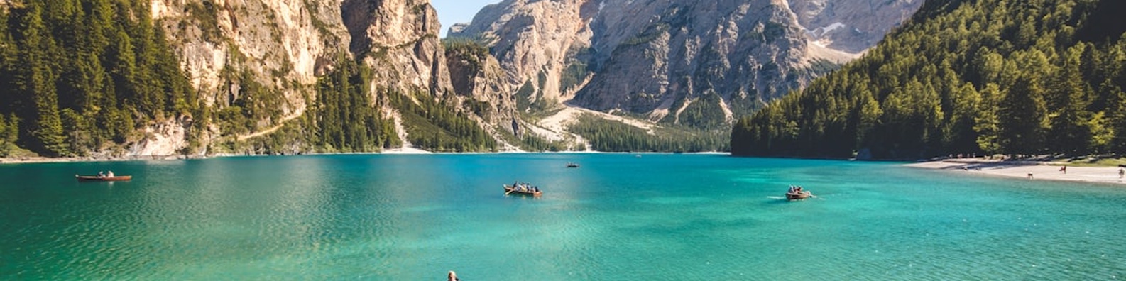 Nature LinkedIn Cover Photo with Wooden Boats on Blue Lake