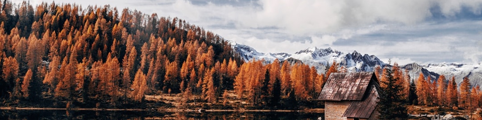 Nature LinkedIn Cover Photo with Wooden Cabin Near Mountain Landscape