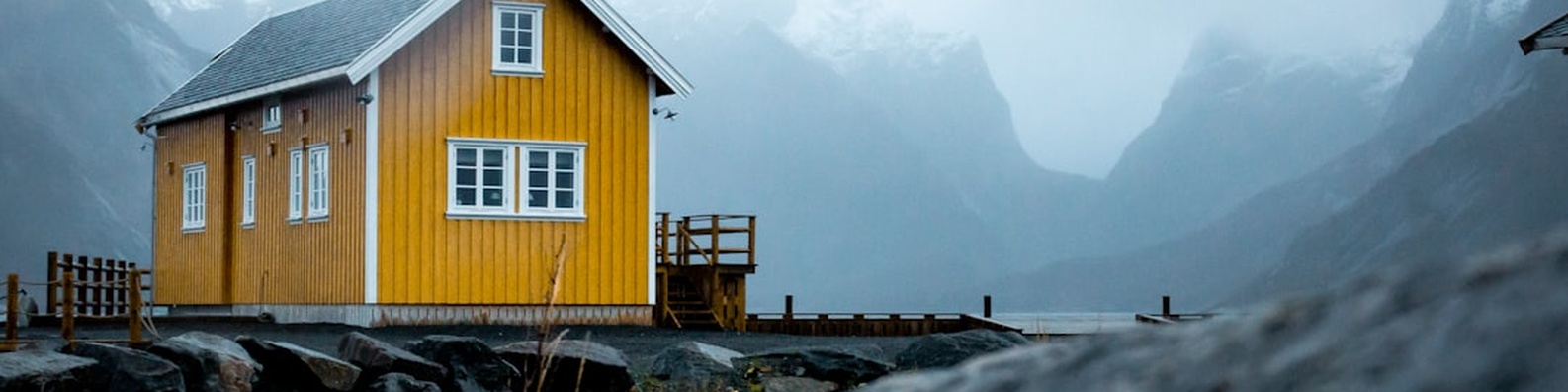 Urban LinkedIn Cover Photo with Yellow House Under Cloudy Sky